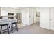 Bright eat-in kitchen featuring white cabinets, stainless steel appliances, and bar seating at 3685 W Union Ave, Denver, CO 80236