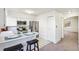 Bright eat-in kitchen featuring stainless steel appliances, white cabinets, and bar seating at 3685 W Union Ave, Denver, CO 80236