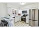 Bright eat-in kitchen with white cabinets, stainless steel appliances, and stylish flooring at 3685 W Union Ave, Denver, CO 80236