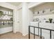Laundry room area includes open shelving and a full-size washer and dryer at 3685 W Union Ave, Denver, CO 80236