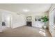 Bright living room featuring neutral carpet, fireplace, and fresh white walls at 3685 W Union Ave, Denver, CO 80236