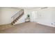 Inviting living space with staircase, neutral carpet, and natural light at 3685 W Union Ave, Denver, CO 80236