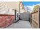 The fenced patio features both brick and vinyl siding plus sliding glass door access to the home at 3685 W Union Ave, Denver, CO 80236