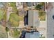 A beautiful backyard with a green lawn, deck, and patio, surrounded by trees and gardens, captured from an aerial perspective at 7313 W 98Th Pl, Broomfield, CO 80021