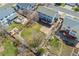 Aerial view of a well-maintained backyard with lush green lawn, large deck, patio area, and landscaped garden at 7313 W 98Th Pl, Broomfield, CO 80021