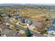 Aerial view of a suburban home highlighting its well-manicured lawn, mature trees, and convenient location at 7313 W 98Th Pl, Broomfield, CO 80021