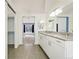 Bathroom features double sink vanity and view into sunlit bedroom at 7313 W 98Th Pl, Broomfield, CO 80021