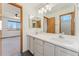 En suite bathroom features a double-sink vanity, a large mirror, and tile floors at 7313 W 98Th Pl, Broomfield, CO 80021