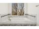 A soaking tub features tile surround, with a window overlooking wooded area at 7313 W 98Th Pl, Broomfield, CO 80021