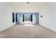 Carpeted bedroom featuring a large window framed by black curtains at 7313 W 98Th Pl, Broomfield, CO 80021