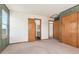 Large bedroom featuring plush neutral carpet, two windows, and two closets at 7313 W 98Th Pl, Broomfield, CO 80021