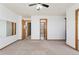 This carpeted bedroom features a ceiling fan, closet, and several entryways at 7313 W 98Th Pl, Broomfield, CO 80021