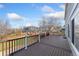 A spacious deck featuring brown decking and white railings, perfect for outdoor entertaining with neighborhood views at 7313 W 98Th Pl, Broomfield, CO 80021
