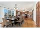 Inviting dining area adjacent to an open kitchen with wood flooring and a sliding glass door to outdoor patio at 7313 W 98Th Pl, Broomfield, CO 80021