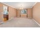 Formal dining room features a large window, neutral carpet, and a chandelier at 7313 W 98Th Pl, Broomfield, CO 80021