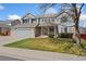 Inviting two-story home featuring a manicured lawn, attached two-car garage, and neutral color palette at 7313 W 98Th Pl, Broomfield, CO 80021