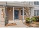 Inviting front porch with brickwork, decorative security door, and manicured landscaping at 7313 W 98Th Pl, Broomfield, CO 80021