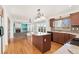 Open-concept kitchen flows into living area, featuring an island, modern appliances, and natural light at 7313 W 98Th Pl, Broomfield, CO 80021