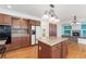 This kitchen features beautiful wood floors and a central island, offering both style and functionality at 7313 W 98Th Pl, Broomfield, CO 80021
