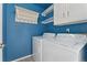 Bright laundry room features a washer, dryer and storage at 7313 W 98Th Pl, Broomfield, CO 80021