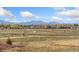 Picturesque view of snow-capped mountains in the distance, visible from the property at 7313 W 98Th Pl, Broomfield, CO 80021