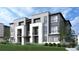 Modern townhome showcasing sleek lines, balconies, and a well-manicured lawn, capturing contemporary elegance at 11940 Soprano Cir # 201, Lone Tree, CO 80134