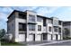 Contemporary townhomes featuring integrated garages and private balconies, presenting a modern, urban lifestyle at 11940 Soprano Cir # 201, Lone Tree, CO 80134