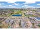 Scenic aerial view of a neighborhood, pond, recreational facilities and the city skyline in the distance at 5943 S Olive Cir, Centennial, CO 80111