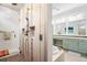 Glass walk-in shower showcases tile, built-in shelves, and a detachable shower head at 5943 S Olive Cir, Centennial, CO 80111
