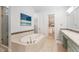 Ensuite bathroom features soaking tub, glass shower, and vanity with walk in closet at 5943 S Olive Cir, Centennial, CO 80111