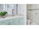 Bathroom featuring a modern vanity, quartz countertop, and walk-in shower with glass door at 5943 S Olive Cir, Centennial, CO 80111