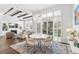 Sunlit dining room features stylish lighting, access to patio, and an open-concept design at 5943 S Olive Cir, Centennial, CO 80111