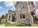 Stunning stone exterior with spiral staircase and a well-maintained lawn at 5943 S Olive Cir, Centennial, CO 80111