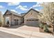 Stunning two-story home with a stone and stucco exterior, a three-car garage and a brick driveway at 5943 S Olive Cir, Centennial, CO 80111