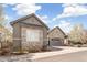 Attractive single-Gathering home featuring a stone and stucco exterior, a two-car garage, and a well-kept lawn at 5943 S Olive Cir, Centennial, CO 80111