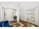 Bright foyer with hardwood floors, high ceilings, a chandelier, and views into another room at 5943 S Olive Cir, Centennial, CO 80111