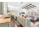 Open kitchen and living room offer wood beams, modern cabinets, and stone countertops at 5943 S Olive Cir, Centennial, CO 80111