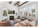Inviting living room with a fireplace, a ceiling fan, hardwood floors, and stylish furnishings at 5943 S Olive Cir, Centennial, CO 80111