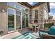 Outdoor patio with comfortable seating, a rug and a view of the landscaped backyard at 5943 S Olive Cir, Centennial, CO 80111