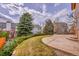Landscaped backyard featuring a patio and manicured lawn at 18736 E Powers Pl, Aurora, CO 80015