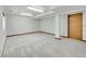 Unfinished basement with neutral carpet, offering a blank canvas for customization and expansion at 18736 E Powers Pl, Aurora, CO 80015