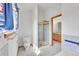 Bright bathroom with a golden-framed shower and tiled sink and vanity at 18736 E Powers Pl, Aurora, CO 80015