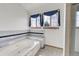 Bright bathroom with tiled tub, decorative window treatments, and a refreshing ambiance at 18736 E Powers Pl, Aurora, CO 80015