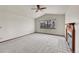 Spacious bedroom with neutral carpet, fireplace, vaulted ceiling, and a bright window at 18736 E Powers Pl, Aurora, CO 80015