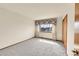 Bright bedroom with soft carpet, a window with floral valance, and a closet at 18736 E Powers Pl, Aurora, CO 80015