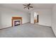 Spacious bedroom with neutral carpet, fireplace, vaulted ceiling, and view into the bathroom at 18736 E Powers Pl, Aurora, CO 80015