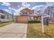 Charming two-story home with a well-manicured front lawn and attached two-car garage at 18736 E Powers Pl, Aurora, CO 80015