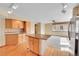 Charming kitchen with island, wooden cabinets, and breakfast bar at 18736 E Powers Pl, Aurora, CO 80015