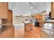 Bright kitchen featuring granite counters, hardwood floors, and an island with additional storage at 18736 E Powers Pl, Aurora, CO 80015