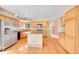 Bright kitchen featuring granite counters, hardwood floors, an island and stainless steel appliances at 18736 E Powers Pl, Aurora, CO 80015